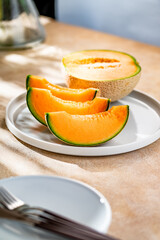 A sweet melon on a plate.
A melon or cantaloupe is a sweet fruit dessert. 
