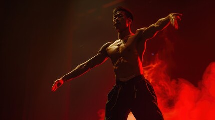 Fototapeta premium A man dances on stage with red lighting