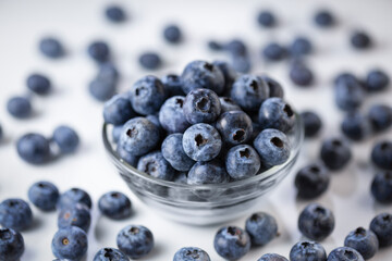 Ripe blueberries in a bowl close-up, source of vitamins and lutein