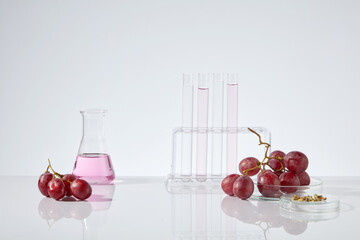 White background photo with laboratory layout and grape ingredient, grape seed essential oil...