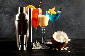 Summer cocktails in classic glasses on a black background. Party time. Tasty drinks