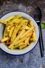  Home made   Fresh fried French fries  in a bowl on wooden rustic  background
