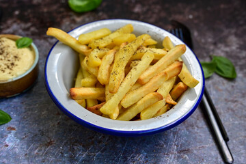  Home made   Fresh fried French fries  in a bowl on wooden rustic  background