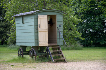 vintage green shepherd's hut in the English countryside