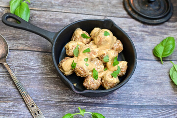 Homemade Swedish Meatballs  With creamy gravy sause in black pan skillet.Swedish cuisine.