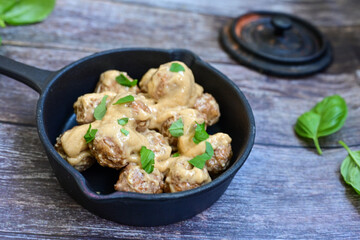 Homemade Swedish Meatballs  With creamy gravy sause in black pan skillet.Swedish cuisine.