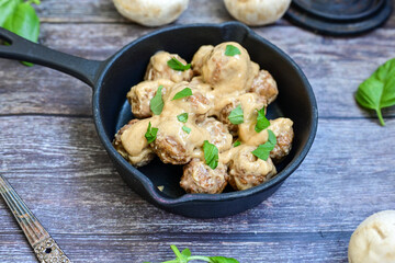 Homemade Swedish Meatballs  With creamy gravy sause in black pan skillet.Swedish cuisine.