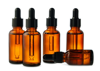 Amber Glass Dropper Bottles With Liquid Against a White Background