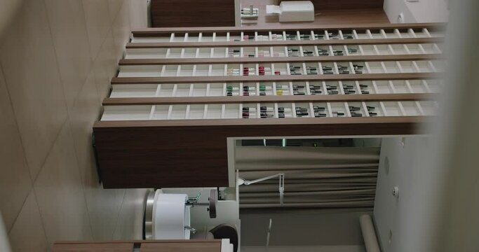 A high angle view of a stylish nail salon interior featuring neatly organized shelves filled with a wide selection of nail polish colors.Modern Nail Salon Interior With Neatly Organized Polish Shelves