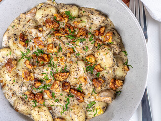 A serving of Potato Gnocchi in a creamy sauce with Walnuts
