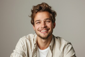 Obraz premium Portrait of attractive glad cheerful man over neutral background