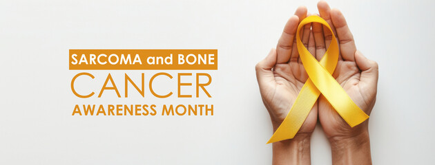 A person holding a yellow ribbon that says Sarcoma