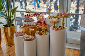 Wedding Reception Dessert Display With Pink and Gold Decorations