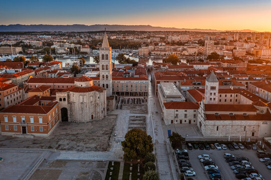 Zadar, Croatia - Aerial view of the Forum of the old town of Zadar with the Church of St. Donatus and the bell tower of the Cathedral of St. Anastasia on a summer morning with golden sky