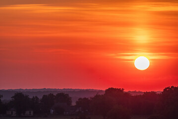 Obraz premium Sunrise against a cloudy red sky in a Ukrainian village