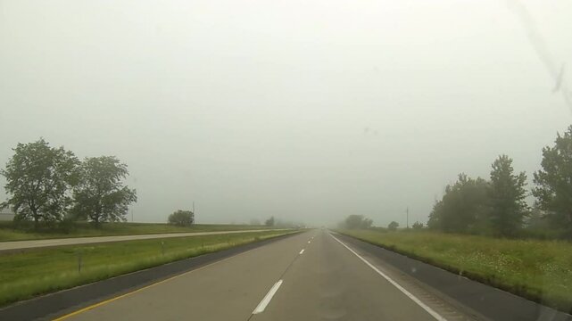 Driving point-of-view traveling in foggy conditions.
