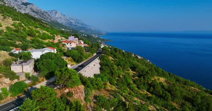 Drone tracking cars on the Makarska riviera coastline in Croatia, summer day