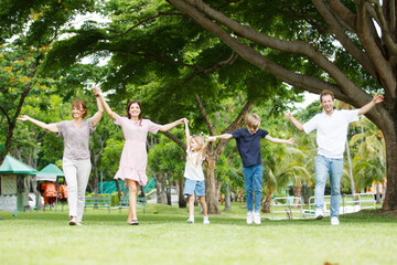 Obraz premium Family with children walking at the park.