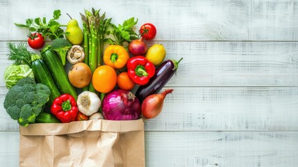 Paper bag filled with vibrant vegetables and fruits on a white wooden background, ideal for organic market concepts.