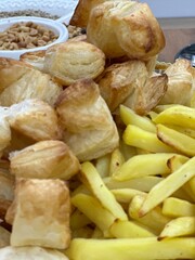 Close-Up of a Bowl of French Fries and Fried Dough - Capturing the Delicious Crunch of Snack Time