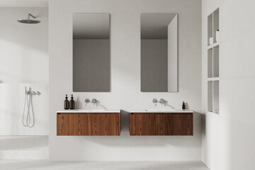 Minimalist hotel bathroom interior with double sink and shower, accessories