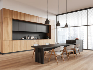 Wooden home kitchen interior with dining table and island, panoramic window