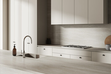 Light home kitchen interior with stone island, sink and cooking cabinet