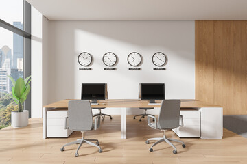 Modern co-working office space with desks, chairs, computers, and clocks on the wall, bright interior, city view, office concept.  3D Rendering
