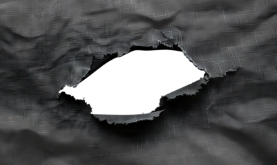 Hole in black fabric with frayed edges, cut out