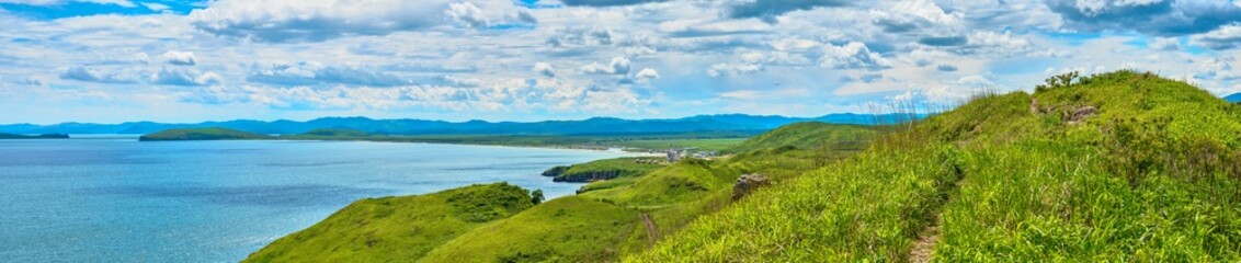 Fototapeta premium The nature of the Khasansky district of Primorsky Krai, Russia. The lip of the Teal of the Slavic Bay, the inner bay of Peter the Great in the summer. Panorama.