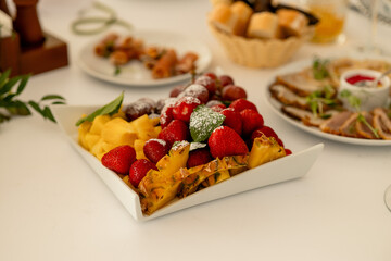 fruits on the banquet table, strawberries, pineapple