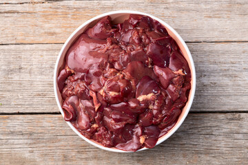 Raw chicken giblets liver, meat background.