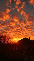Fiery Sky at Sunset Over a House