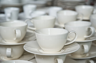 Fototapeta premium Close up of many empty white tea cups for company event hot beverage on tea time, catering and food service banquet preparations abstract concept