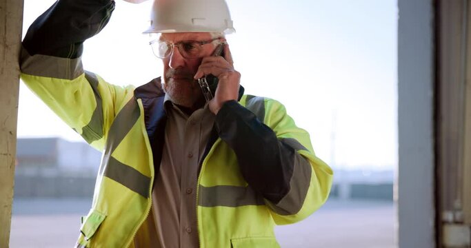 Talking, contractor and phone call on building site for communication and construction project planning. Mobile tech, conversation and man with helmet for progress update, schedule or inspection