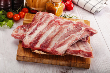 Raw pork ribs over board