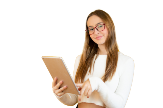 Portrait of a young girl standing holding a tablet looking to camera isolated over transparent background.