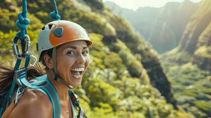 Close up of a happy woman ziplining on a mountain in Hawaii, wearing a helmet and gear for the zip line adventure, looking at the camera in a screaming pose for an action shot. The action photography 
