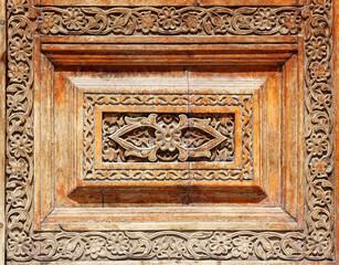 Texture of vintage wood boards with carved decorative border. Vertical or horizontal retro background with old wooden planks and floral ornamen