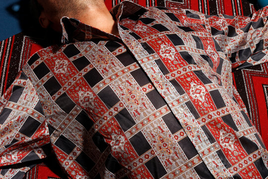 Man lying down in printed shirt