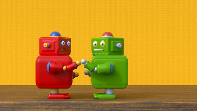 Red and green robots greeting on table in front of yellow textured wall