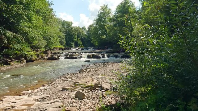 Bright summer scene of Pid Skelyamy waterfall. Picturesque morning view of Sukel' River. Wonderful landscape of Carpathian mounatains, Ukraine, Europe. 4K video (Ultra High Definition).