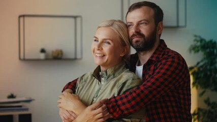 Happy civilian husband embracing loving military wife, close relationship, care