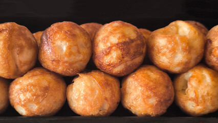 Takoyaki snacks on a black tray, Japanese style food