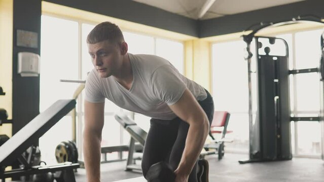 Dedicated male fitness enthusiast showcasing his strength, determination in a rigorous gym workout