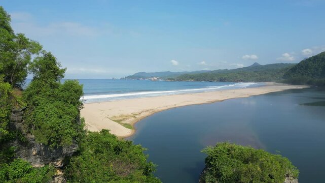 Jungle Covered Rocks At The Edge Of Pantai Soge Beach In Java Indonesia