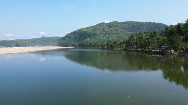 Drone Cruises Above Calm Indonesian Lagoon At Pantai Soge Java