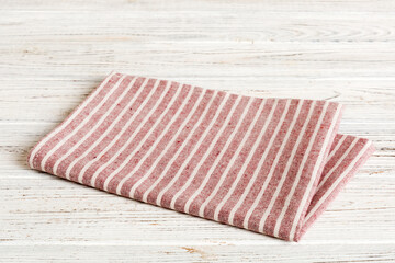top view with red empty kitchen napkin isolated on table background. Folded cloth for mockup with...