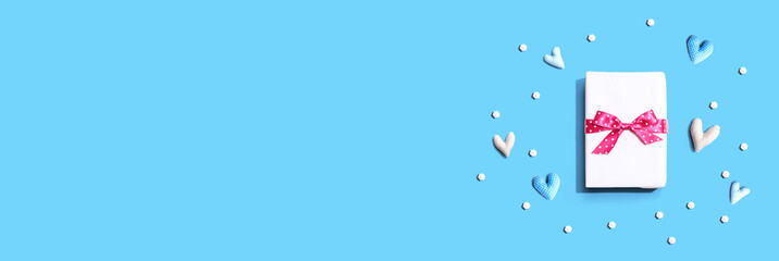 Valentines day or Appreciation theme with a gift box and heart cushions - flat lay