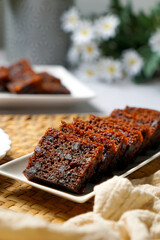 Kek Buah Kukus, a traditional Malaysian steamed fruit cake filled with dried fruits, nuts, and spices, enjoyed during celebrations.